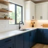 10 kitchen makeover ideas under 1000 – featured image of a budget kitchen with navy lower cabinets, white uppers, black hardware, subway backsplash, and open shelves.