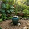 How to add a water feature to a small garden – featured image showing bubbling urn, wall fountain, and container water garden in a compact space.