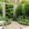 How to make a tiny garden feel bigger – featured image showing mirror illusion, vertical wall, curved path, light furniture, and layered planting.
