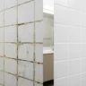 How to regrout bathroom tiles without a full renovation – featured image showing before and after comparison of cracked grout transformed to fresh white grout.
