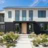 Two-tone exterior paint ideas for modern homes – featured image of a white and charcoal black modern home.
